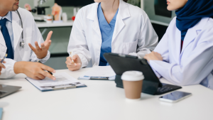 Healthcare professionals reviewing data and discussing vaccine policy decisions during a training workshop