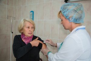 older woman in moldova receives flu vaccine