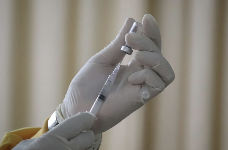 medical professional holds vaccine